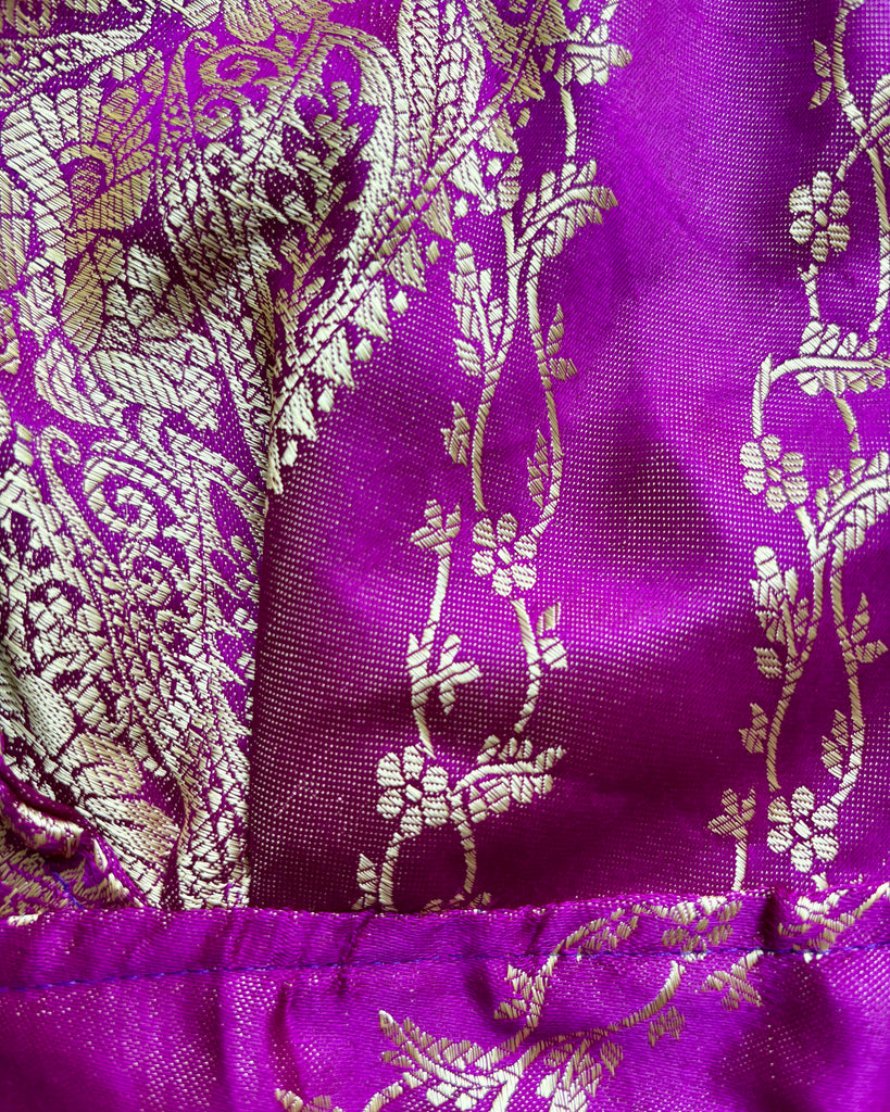 Close-up of purple fabric with gold floral patterns